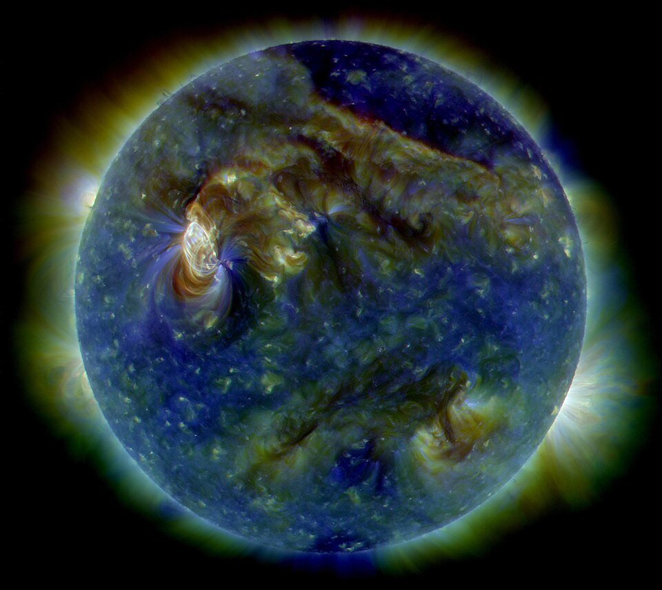An archival false-color view of the Sun showing bright active regions and the solar corona.